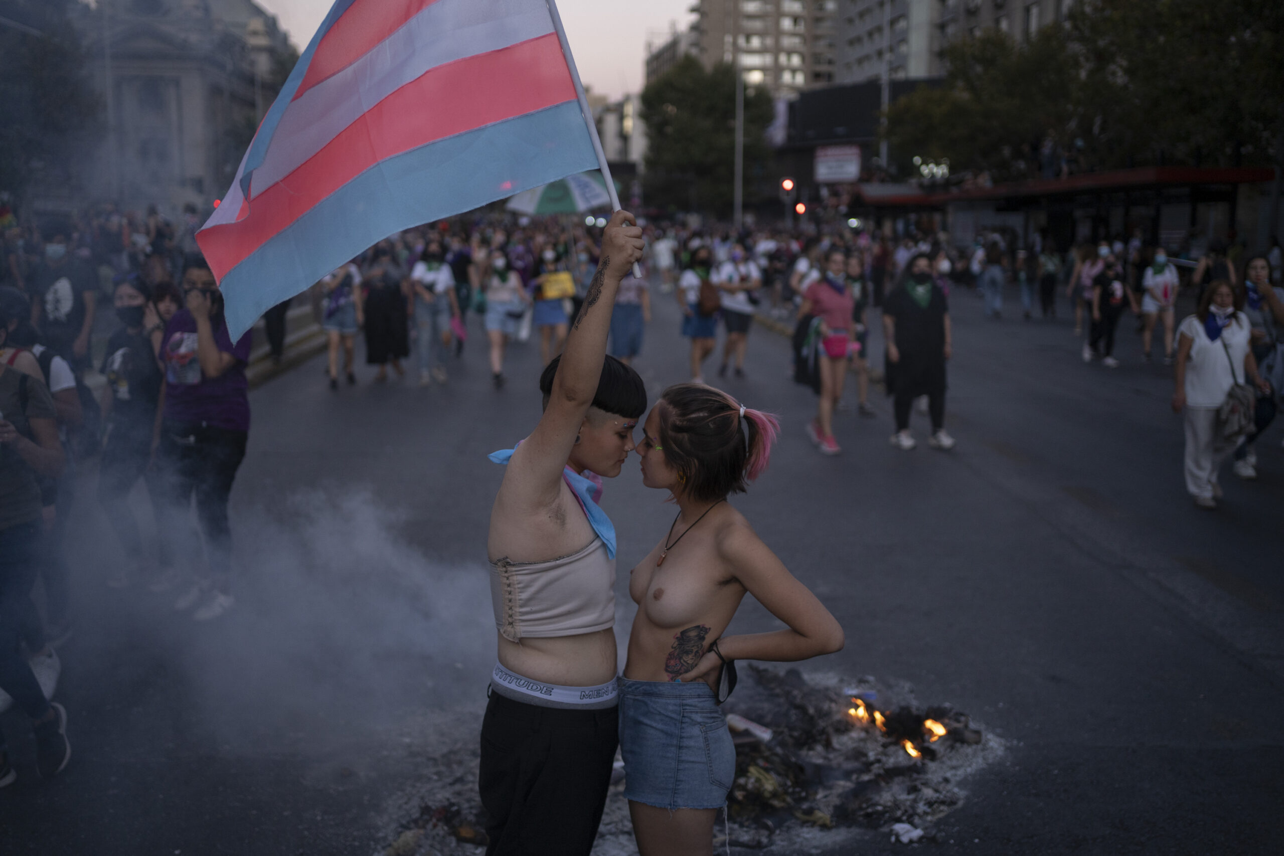 Two protestors pause during a march on the occasion of International Women's Day, in Santiago, Chile, March 8, 2022.