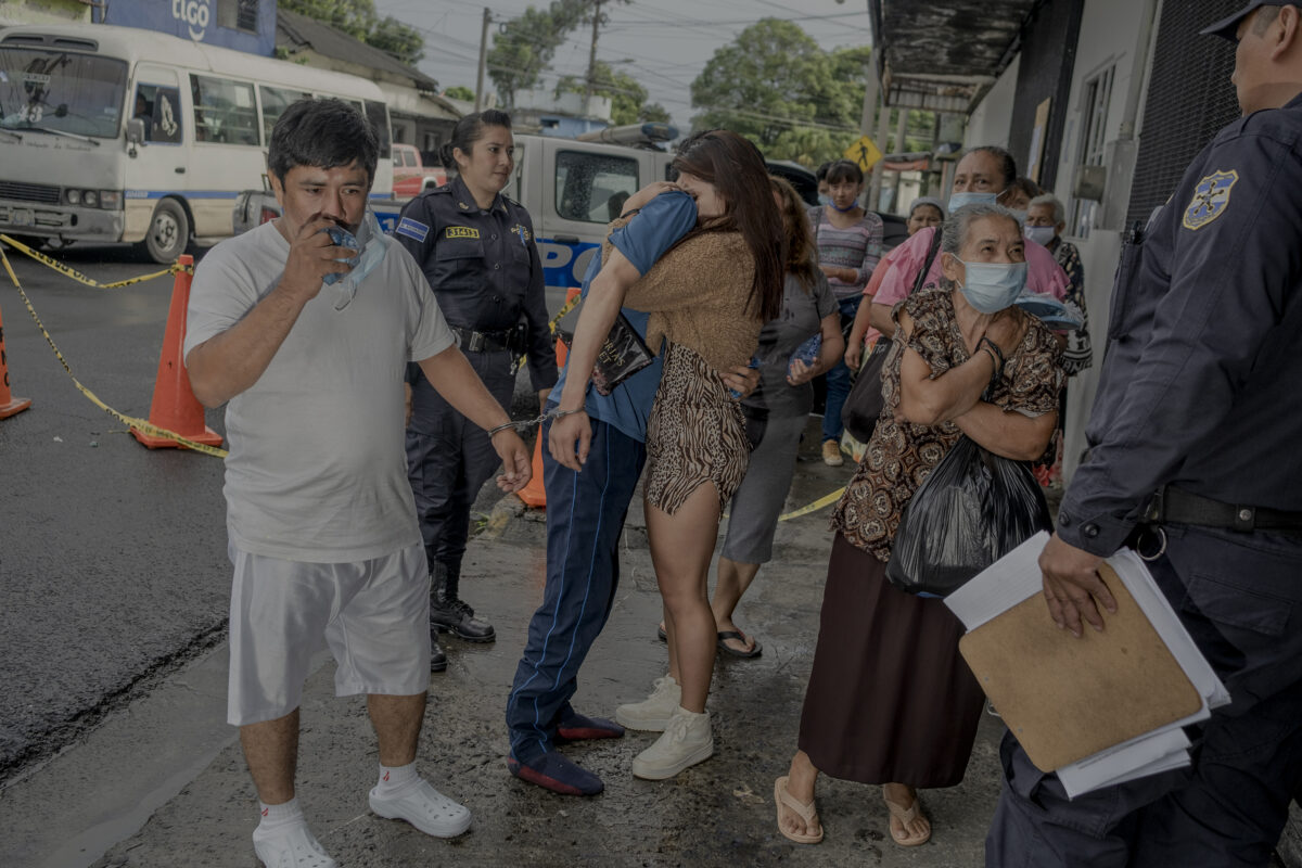 A woman hugs her boyfriend before police officers take him into a provisional detention center, other women ask for their relatives arrested on June 16th, 2022 in San Salvador, El Salvador. Since the end of March 58,000 people, included 1.600 kids, have been arrested in El Salvador during the state of emergency declared by President Nayib Bukele to fight gangs.
